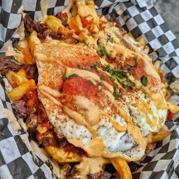 El Burro Loco's loaded Mexican fries with steak, cheese sauce, fried eggs, and spices.